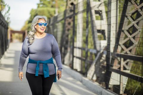 Woman Walking on Bridge