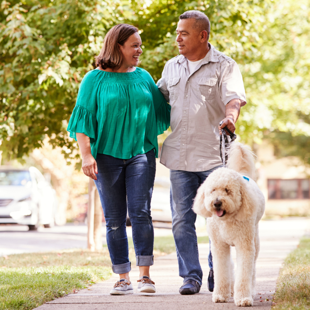 Couple walking dog outside